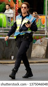 Coruna / Spain - April 19 2019: Humourless Female Police Officer Glares At The Camera In Spain