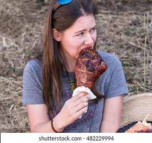 Corvallis, Oregon - September 11, 2016 - Caucasian Woman Eating Roasted Turkey Leg At Renaissance Fair In Rural Corvallis, Oregon.