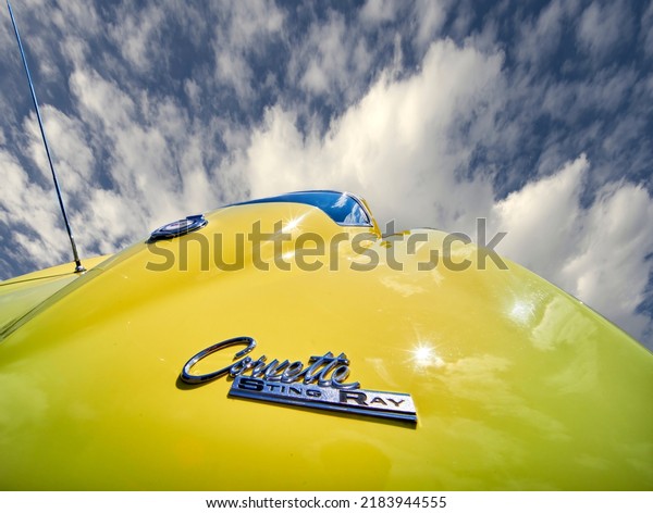 Corvette Stingray lettering and logo of the classic\
car on yellow paint, photographed with wide angle in Hanover,\
Germany, July 23, 2022