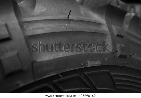 Cose up of mud terrain tyre. Used tires dark\
background. off-road. new car tyre. Close up of black car tire. big\
jungle trekker.