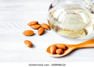 cosmetic almond oil in glass bottle on wooden background
