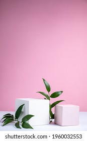 Cosmetic background with geometric shapes on a pink backdrop. Two cubic podiums and green leaves. Abstract background. Mockup for the demonstration of cosmetic products. - Shutterstock ID 1960032553