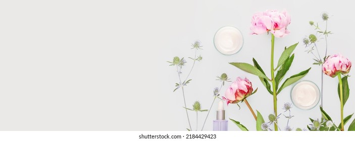 Premium Photo  Pink cosmetic containers. skin care cosmetic bottles on  floral background