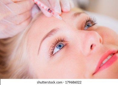 Cosmetic botox injection in the female face, eye and eyebrow zone