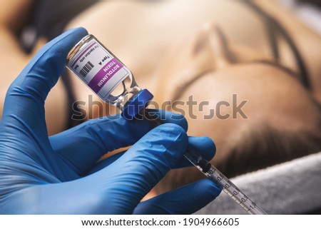cosmetic botox injection. filling syringe with botulinum toxin