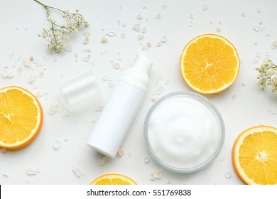 Cosmetic Bottle Containers With Fresh Orange Slices, Blank Label For Branding Mock-up, Natural Vitamin C Beauty Product Concept.