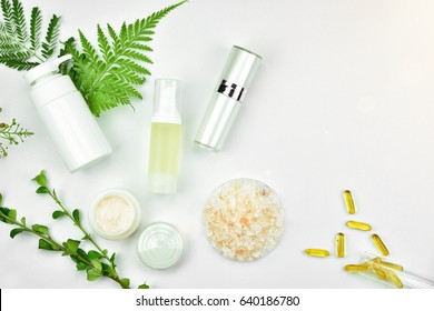 Cosmetic Bottle Containers With Green Herbal Leaves, Blank Label Package For Branding Mock-up, Natural Organic Beauty Product Concept.