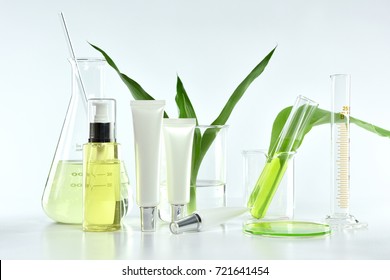 Cosmetic Bottle Containers With Green Herbal Leaves And Scientific Glassware, Blank Label Package For Branding Mock-up, Research And Develop Natural Organic Beauty Skincare Product Concept.