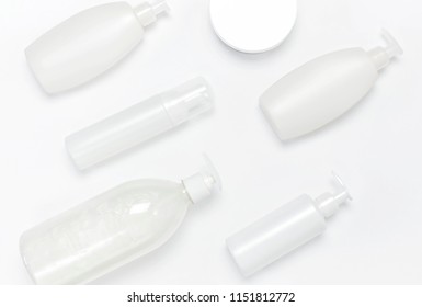 Cosmetic Bottle Containers On White Background Flat Lay Top View. Blank Label For Branding Mock-up. Natural Beauty Product Concept. Shower Gel, Shampoo, Liquid Soap Without Labels.