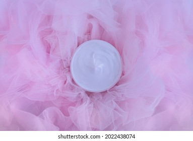 
Cosmetic Bottle Of Cream Lotion On Pink Tulle Fabric