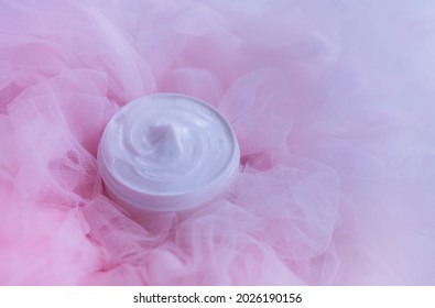 Cosmetic Bottle Of Cream Lotion On Pink Tulle Fabric