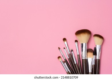 Cosmetic brushes, everyday makeup tools on pink background, closeup. Flatlay. - Powered by Shutterstock