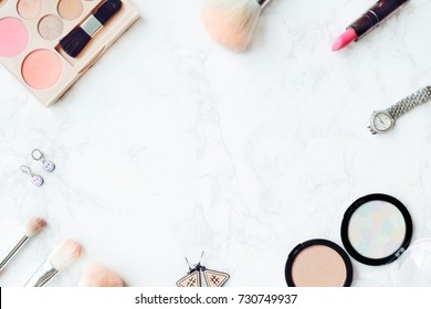 Cosmetic Composition. Pink Brush Set, Lipstick, Earring, Blush On, Watch And  Eyeshadow Palette On Marble Table. Cosmetic Dressing Table For Women Make Up Concept. Flat Lay, Top View. Copy Space.