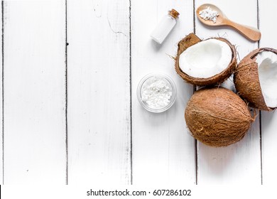 cosmetic concept with fresh coconuts on white table background top view