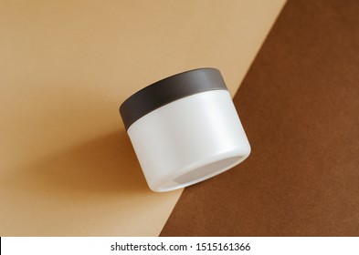 Cosmetic Cream, Balm Jar Mockup On Brown Background. Makeup Product Blank Container. Body Care Cosmetics, Cleaning Scrub In Modern Packaging. Facial Skincare, Moisturising Mask For Hair Closeup Image