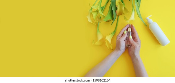 cosmetic cream, female hands, calla flower on a colored background - Shutterstock ID 1598102164