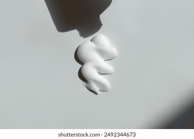 Cosmetic cream or sun cream squeezed from a bottle
