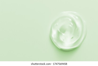 Cosmetic Gel Drop. Hand Sanitizer, Alcohol Gel Blob On Pastel Green Background. Transparent Cream Swirl. Skin Care Product Sample Close Up