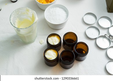 cosmetic lotion cream diy do it yourself ingredients creamer arrangement on white textile cloth top view