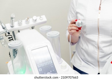 Cosmetic Machine In The Beautician Office. Beautician Holding In His Hands Ice Skin Repairing Treatment Head