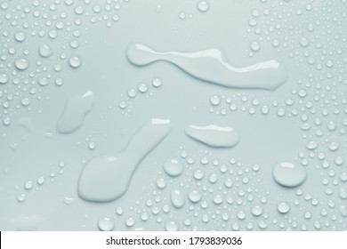 Cosmetic moisturizing liquid drops on gray mint pastel background. Toner or lotion. Hyaluronic serum