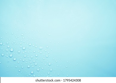 Cosmetic moisturizing liquid drops on light gray blue  background. Toner or lotion. Hyaluronic serum