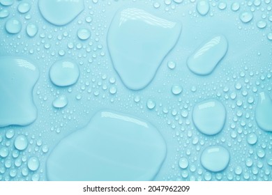 Cosmetic moisturizing liquid drops on green blue pastel background. Toner or lotion. Hyaluronic serum