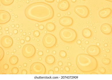 Cosmetic moisturizing liquid drops on yellow pastel background. Toner or lotion. Hyaluronic serum