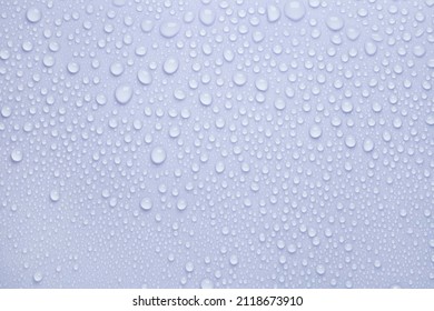 Cosmetic moisturizing liquid drops on blue pastel background. Toner or lotion. Hyaluronic serum