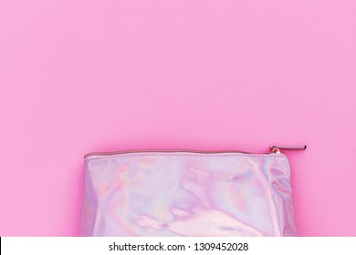 Cosmetic Pink Bag, Close Up. Holographic Makeup Bag With Metallic Zipper Lies On Pink Background.  Travel Bag For Make Up Or Cosmetic, Copy Space, Text Place