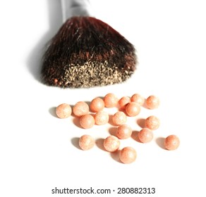 Cosmetic powder balls and makeup brush, isolated on white