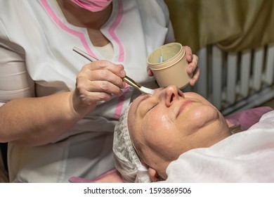 A Cosmetic Procedure With Ultrasonic Cleaning Of The Skin Of The Face Is Performed For An Aged Woman. Skin Surface Preparation. A Series Of Sequential Operations.