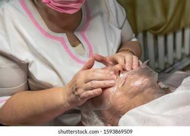 A Cosmetic Procedure With Ultrasonic Cleaning Of The Skin Of The Face Is Performed For An Aged Woman. Skin Surface Preparation. A Series Of Sequential Operations.