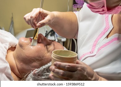 A Cosmetic Procedure With Ultrasonic Cleaning Of The Skin Of The Face Is Performed For An Aged Woman. Skin Surface Preparation. A Series Of Sequential Operations.