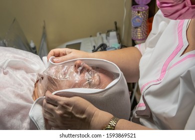 A Cosmetic Procedure With Ultrasonic Cleaning Of The Skin Of The Face Is Performed For An Aged Woman. Skin Surface Preparation. A Series Of Sequential Operations.