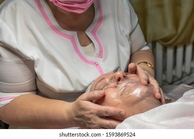 A Cosmetic Procedure With Ultrasonic Cleaning Of The Skin Of The Face Is Performed For An Aged Woman. Skin Surface Preparation. A Series Of Sequential Operations.