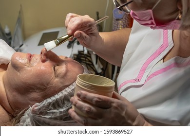 A Cosmetic Procedure With Ultrasonic Cleaning Of The Skin Of The Face Is Performed For An Aged Woman. Skin Surface Preparation. A Series Of Sequential Operations.