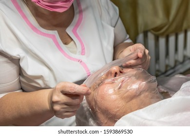 A Cosmetic Procedure With Ultrasonic Cleaning Of The Skin Of The Face Is Performed For An Aged Woman. Skin Surface Preparation. A Series Of Sequential Operations.