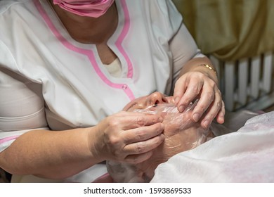 A Cosmetic Procedure With Ultrasonic Cleaning Of The Skin Of The Face Is Performed For An Aged Woman. Skin Surface Preparation. A Series Of Sequential Operations.