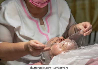 A Cosmetic Procedure With Ultrasonic Cleaning Of The Skin Of The Face Is Performed For An Aged Woman. Skin Surface Preparation. A Series Of Sequential Operations.