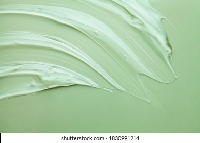 Cosmetic product creamy gel texture smudge on pastel green sage colored background - Shutterstock ID 1830991214