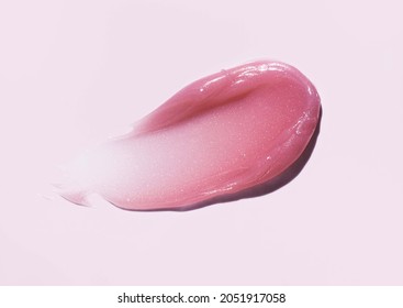 Cosmetic products creamy pink texture smudge pink background