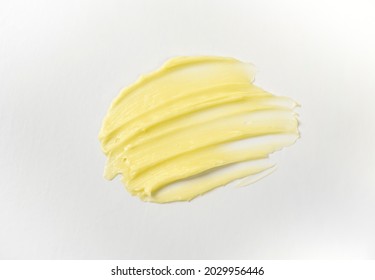 Cosmetic Products Creamy Yellow Stain Texture On A White Background. The Texture Of Natural Cosmetics Hair Mask, Cream, Scrub