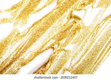 Cosmetic products. Makeup texture. Golden smudged texture of paint, gold face mask, nail polish on white background isolated.