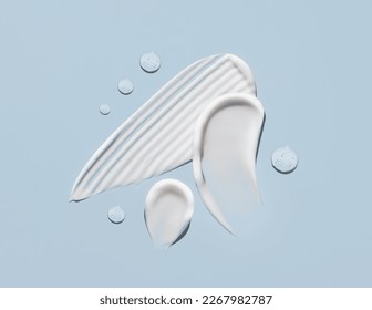 cosmetic smears cream texture on pastel blue background - Shutterstock ID 2267982787