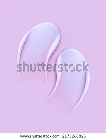 cosmetic smears cream texture on pink background	
