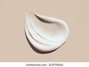 cosmetic smears of creamy texture on a pastel beige background - Shutterstock ID 2179739261