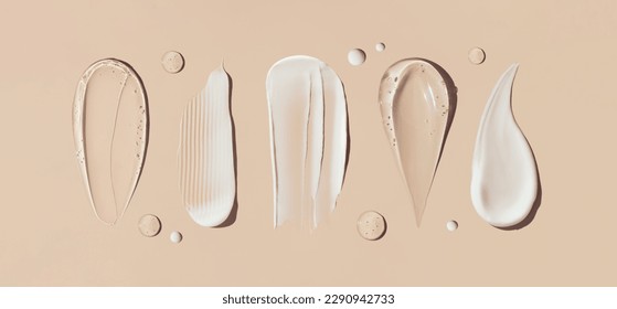 cosmetic smears of creamy texture on a beige background - Shutterstock ID 2290942733
