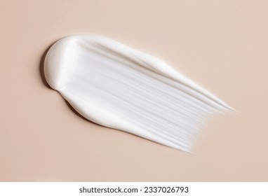 cosmetic smears of creamy texture on a beige background - Shutterstock ID 2337026793