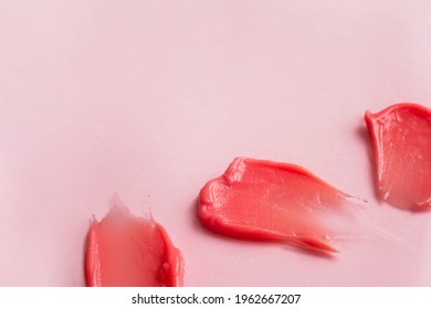 Cosmetic Smears Isolated On Pink Background. Lipstick Or Lip Gloss Swatch Macro Wallpaper. Beauty Swash Texture. Liquid Makeup Product Closeup. Horizontal Banner Template With Copy Space